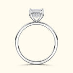 Elegant silver ring featuring a central emerald-cut diamond with smaller accent stones.