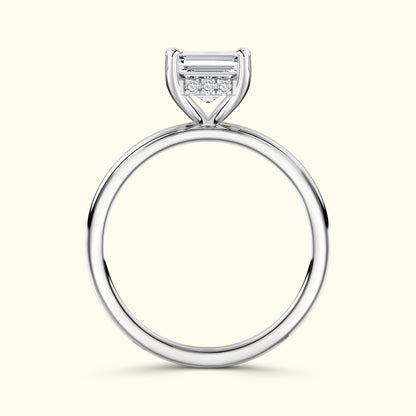 Elegant silver ring featuring a central emerald-cut diamond with smaller accent stones.