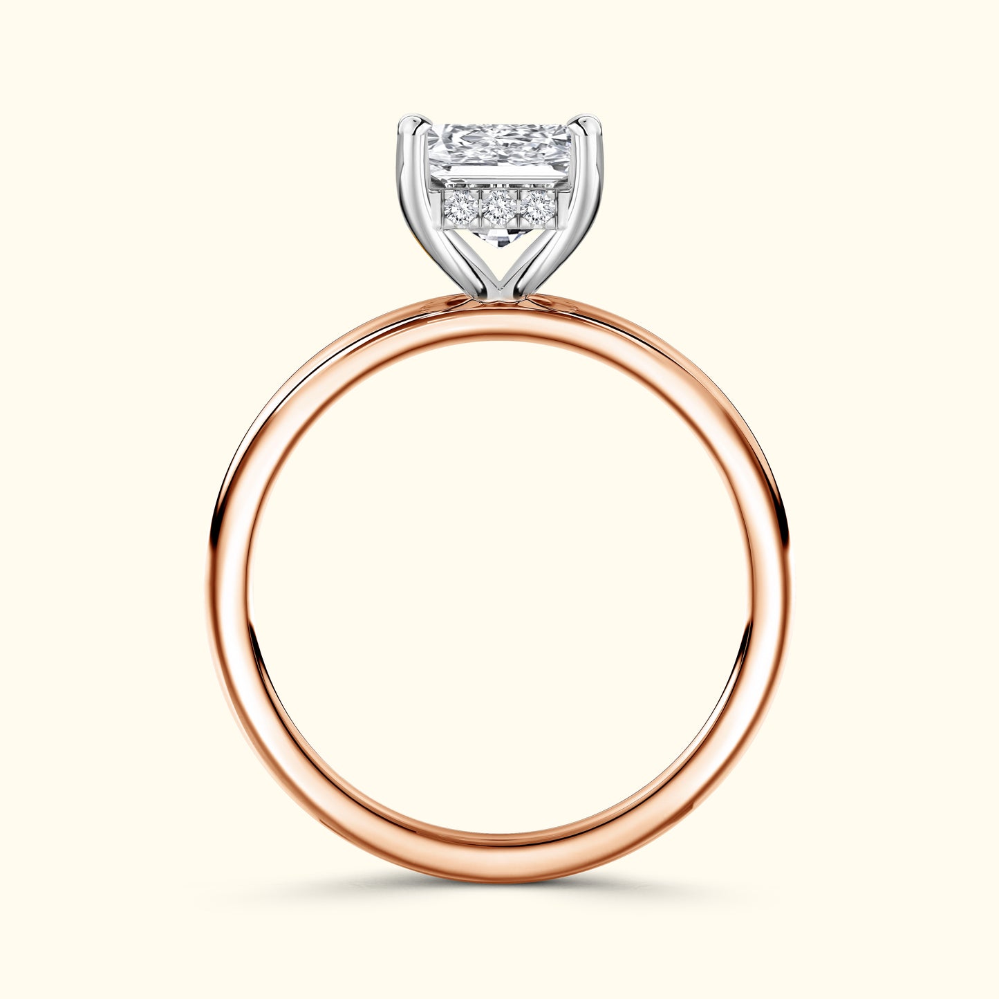 Rose gold ring featuring a rectangular diamond setting and four smaller diamonds.