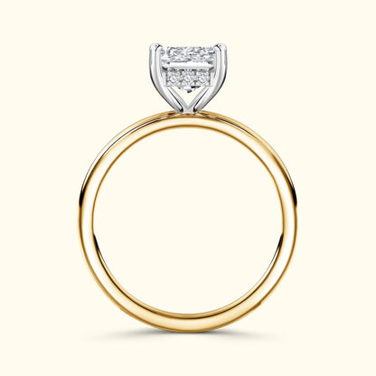 Gold and silver engagement ring with a large rectangular diamond setting.