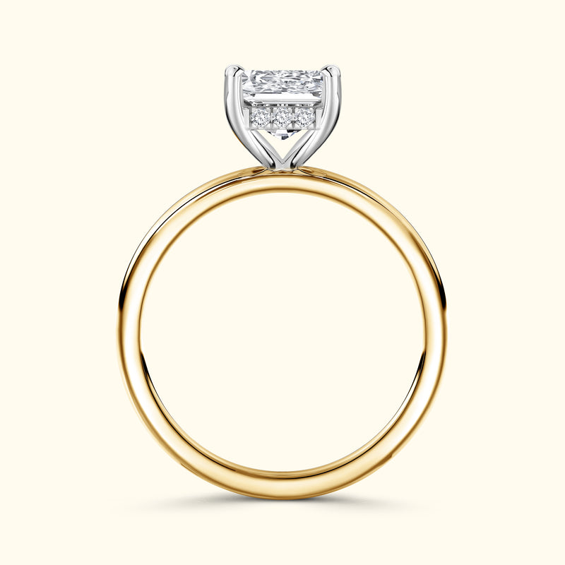 Gold and silver engagement ring with a large rectangular diamond setting.
