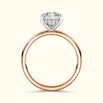 Elegant rose gold ring featuring a large diamond centerpiece and small accent diamonds.