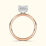 Rose gold ring featuring a rectangular diamond and smaller accent stones.