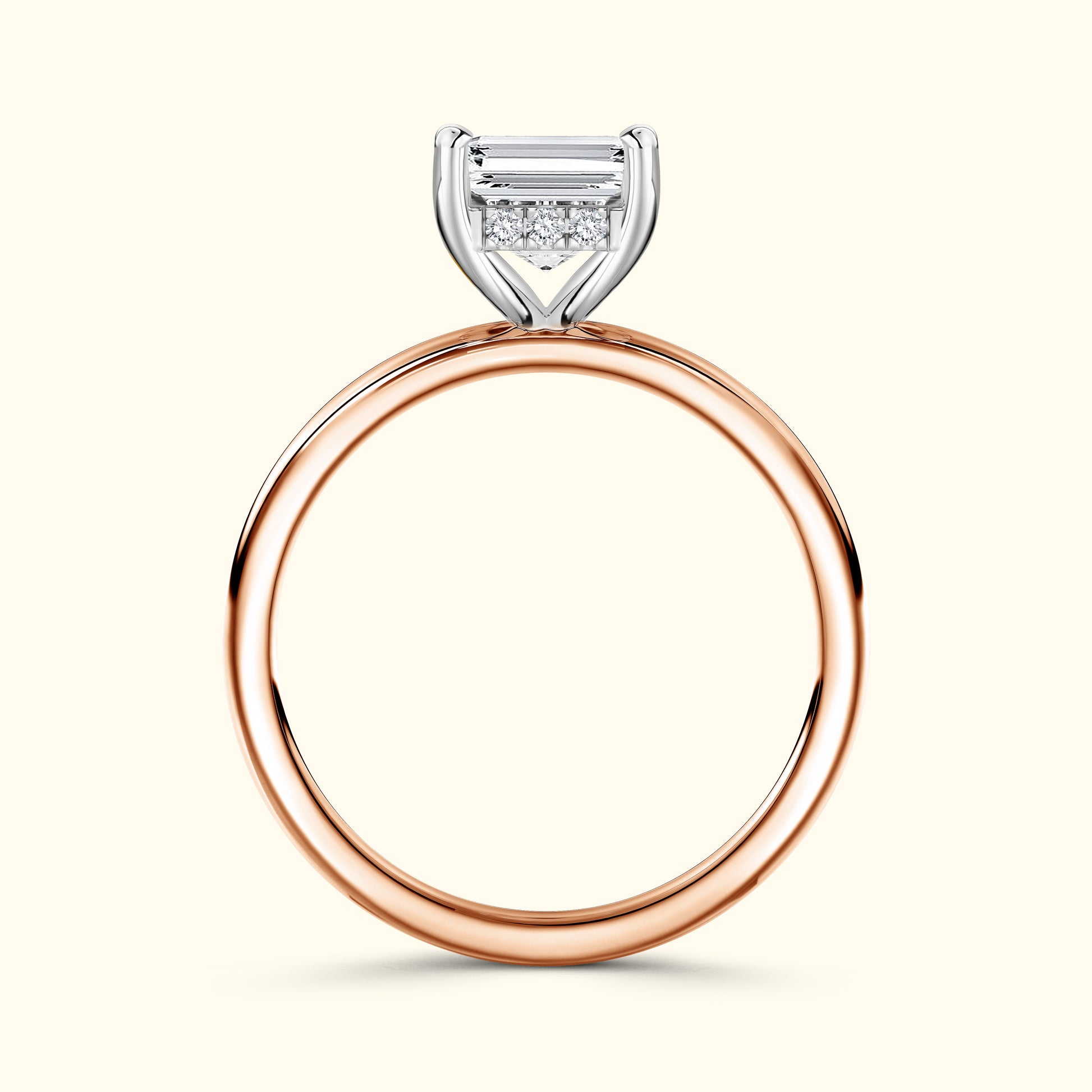 Rose gold ring featuring a rectangular diamond and smaller accent stones.