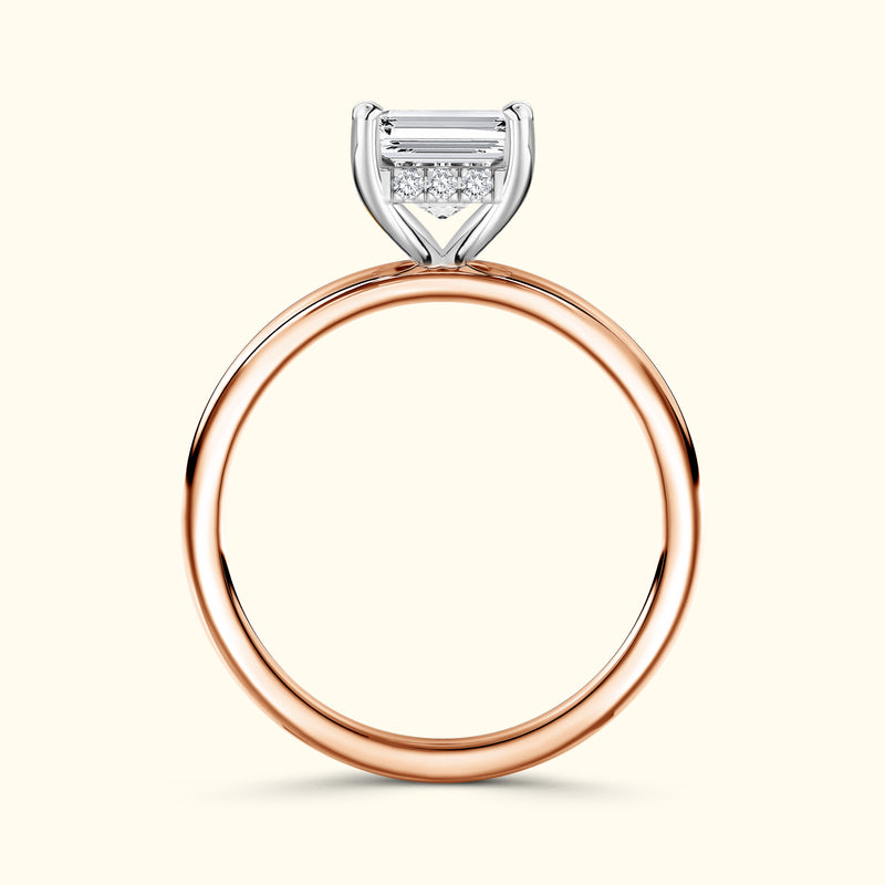 Rose gold ring featuring a rectangular diamond and smaller accent stones.