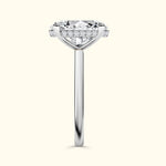 Brilliant diamond ring with a round center stone and halo of smaller diamonds on a sleek band.