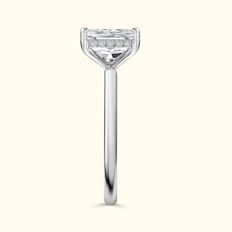 Sleek silver engagement ring featuring a prominent diamond atop a slender band.