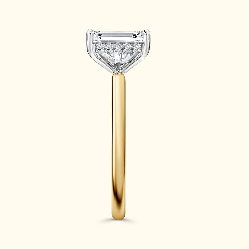 A sleek gold ring with a clear diamond-shaped centerpiece glistening on top.
