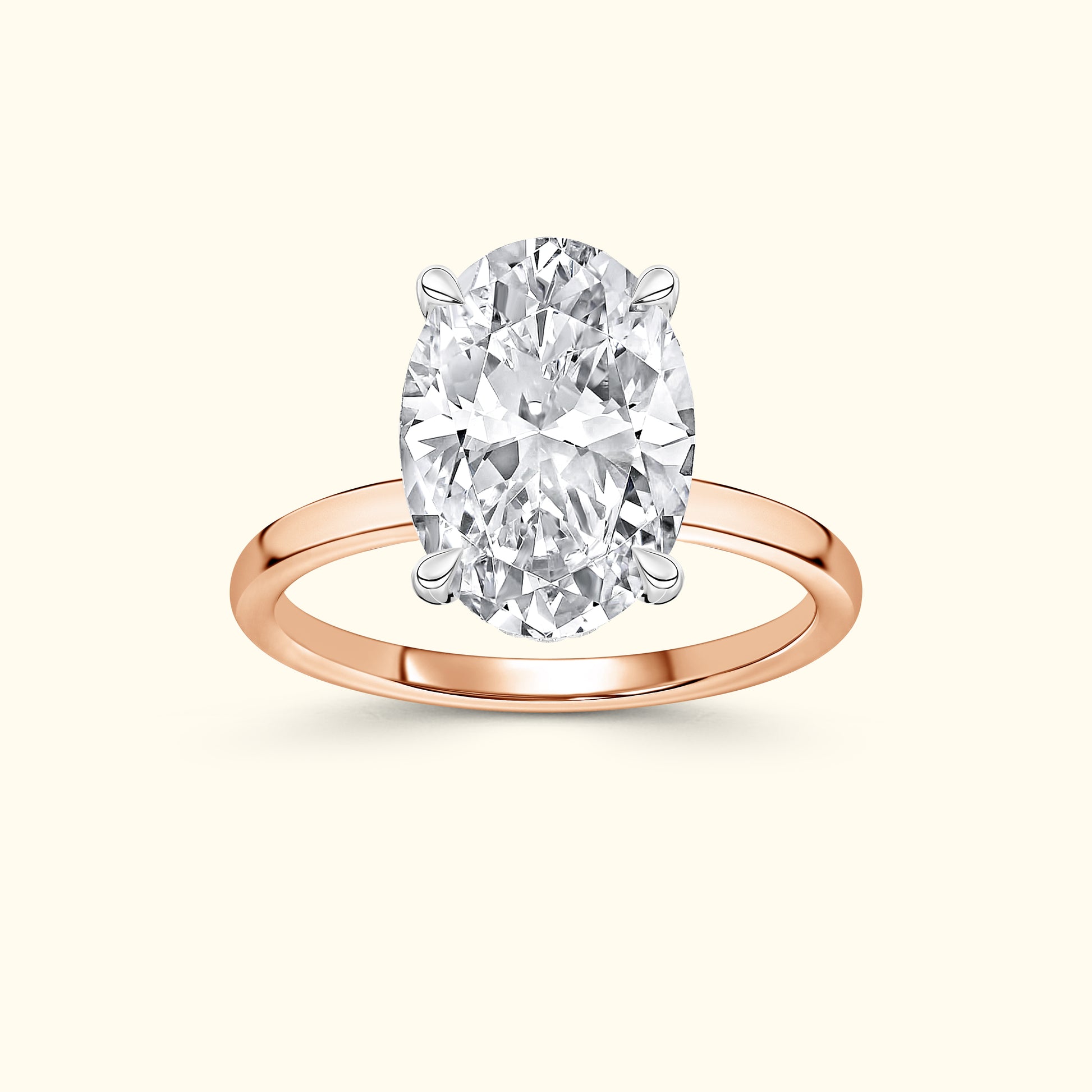 Oval diamond ring with a rose gold band on a neutral background.