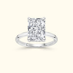 Elegant rectangular diamond ring set in a polished silver band.