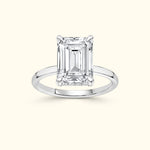 Elegant silver ring featuring a large emerald-cut diamond centerpiece.
