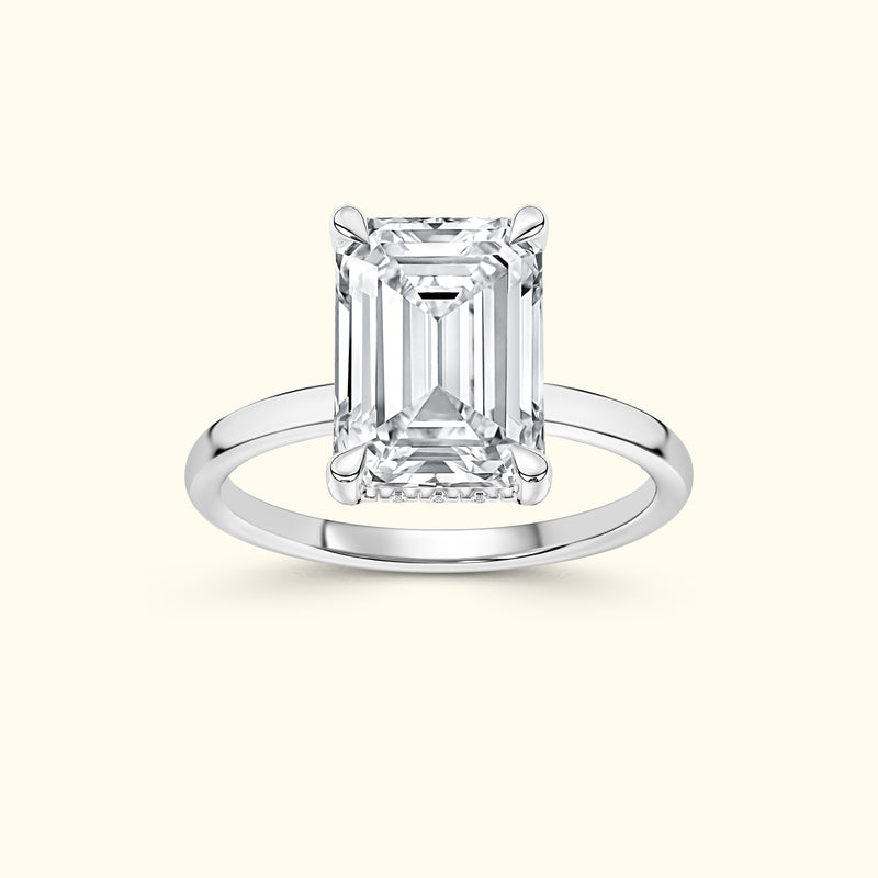 Elegant silver ring featuring a large emerald-cut diamond centerpiece.