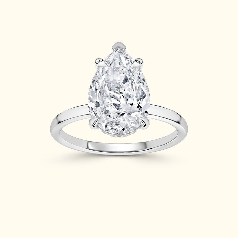 Elegant pear-shaped diamond ring set in a sleek white gold band.