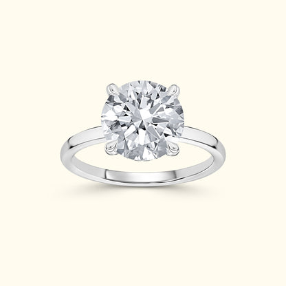 Solitaire diamond ring with a round cut stone on a sleek white gold band.