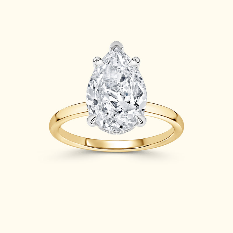 Teardrop-shaped diamond ring set in a yellow gold band.