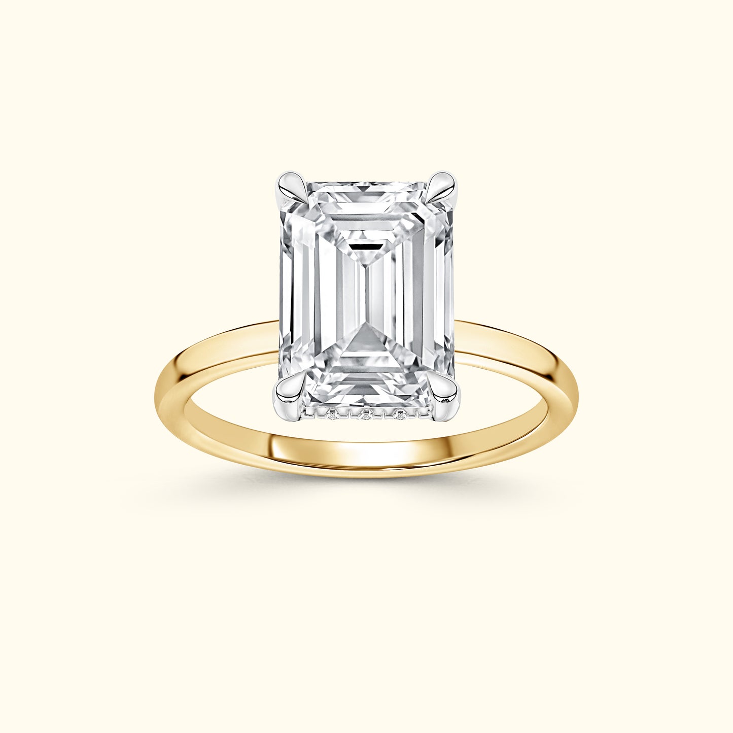 Emerald-cut diamond ring on a simple yellow gold band, elegant and refined.