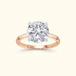 Rose gold ring featuring a large round diamond set in a four-prong setting.