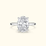 Oval diamond engagement ring with a sleek silver band.