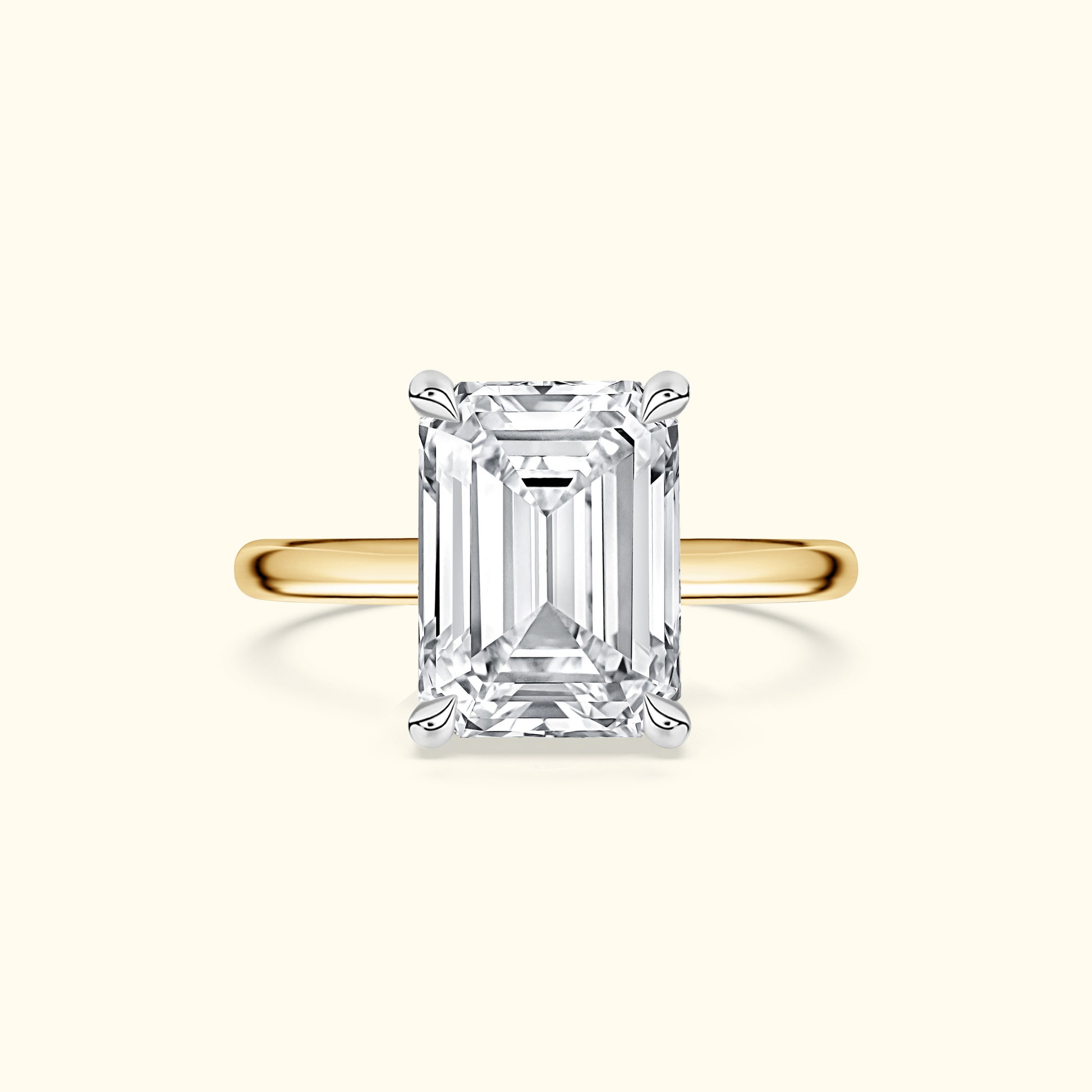 Emerald-cut diamond ring with a yellow gold band.