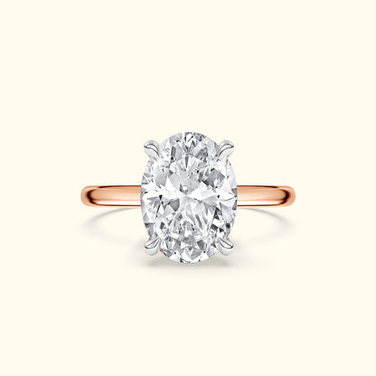 Oval diamond engagement ring with a rose gold band.