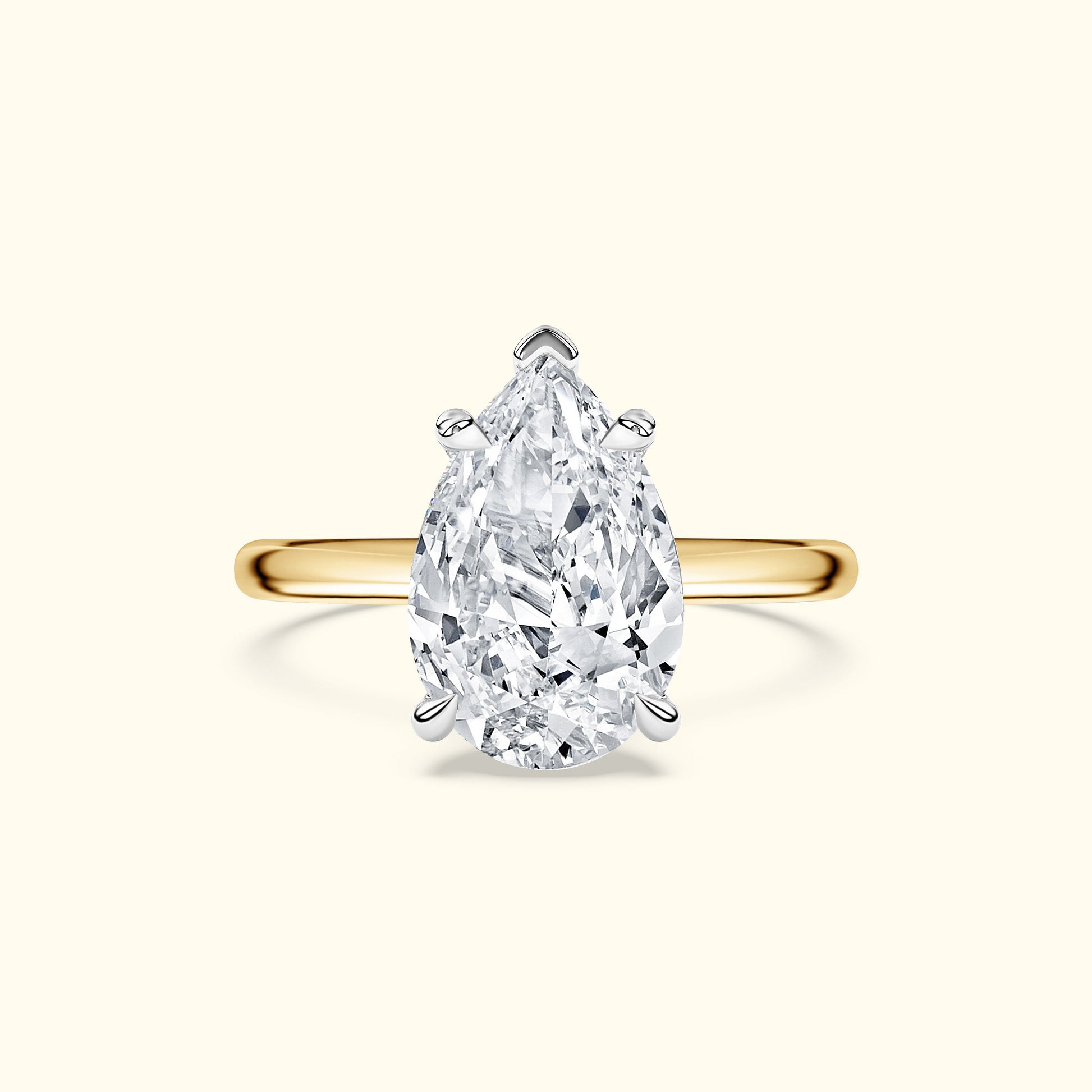 Pear-shaped diamond ring with a yellow gold band.