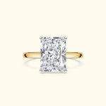 Rectangular diamond engagement ring with a yellow gold band.
