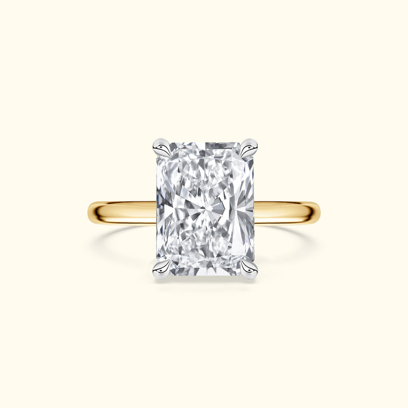 Rectangular diamond engagement ring with a yellow gold band.