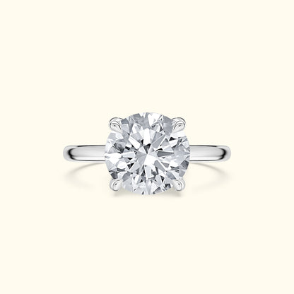 Elegant diamond engagement ring with a round cut stone and a sleek silver band.