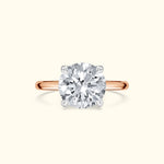 A sparkling round diamond ring with a rose gold band.