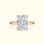 Elegant rectangular diamond ring with a rose gold band.