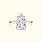 Teardrop-shaped diamond ring with a rose gold band.