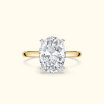 Gold ring featuring a large oval diamond set in a silver prong setting.