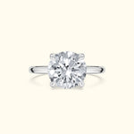 Solitaire diamond engagement ring with a round cut stone on a polished silver band.