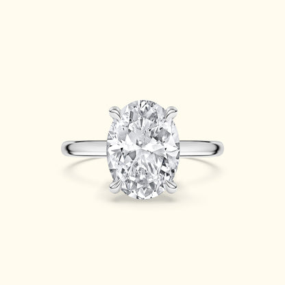 Oval diamond engagement ring set in a sleek silver band.