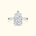Teardrop-shaped diamond ring set in a polished silver band.