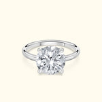 Classic solitaire ring with a large round diamond set in a polished white gold band.