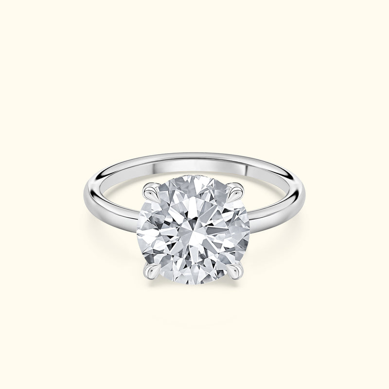 Classic solitaire ring with a large round diamond set in a polished white gold band.