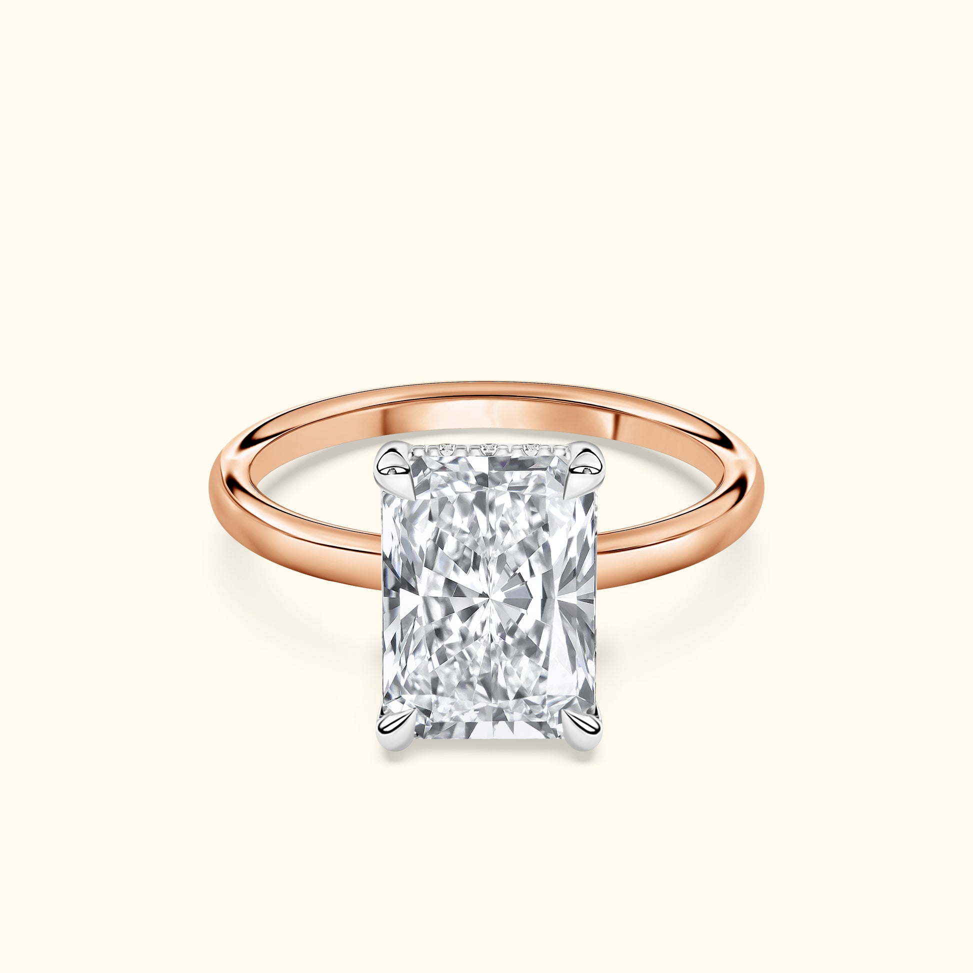 A rose gold ring featuring a large, rectangular diamond in a four-prong setting.