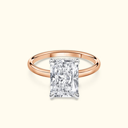 A rose gold ring featuring a large, rectangular diamond in a four-prong setting.