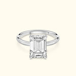 Elegant solitaire ring featuring a rectangular diamond set in a sleek white gold band.