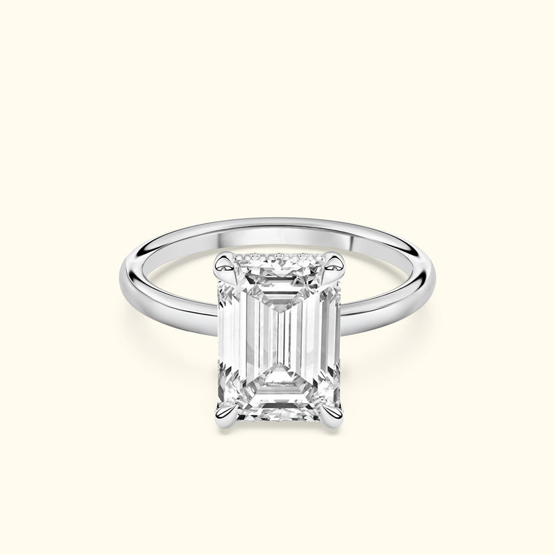 Elegant solitaire ring featuring a rectangular diamond set in a sleek white gold band.