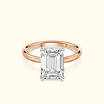 Elegant emerald-cut diamond ring set on a rose gold band.