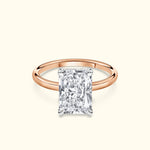 Rose gold ring featuring a large rectangular diamond solitaire.