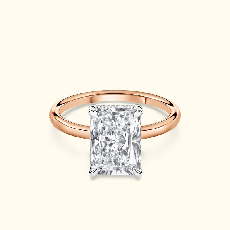 Rose gold ring featuring a large rectangular diamond solitaire.