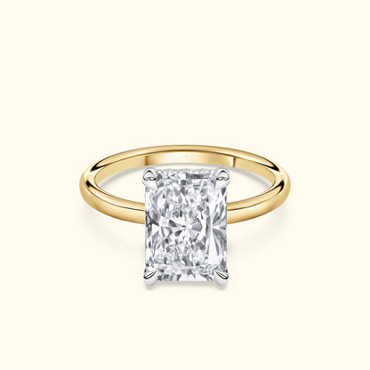 Rectangular diamond engagement ring with a gold band.