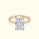 Classic gold ring featuring a large rectangular diamond center stone.