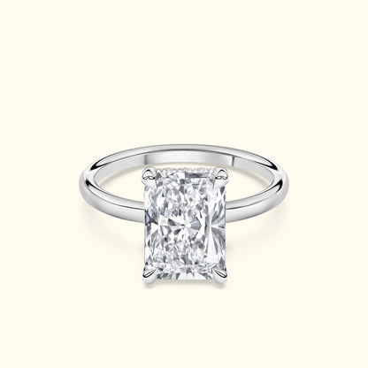 Elegant solitaire ring featuring a large, clear rectangular diamond set in a simple band.