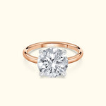 Solitaire engagement ring featuring a large round diamond on a rose gold band.