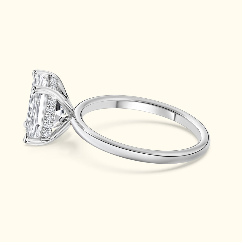 Elegant silver ring featuring a large rectangular diamond and intricate band details.