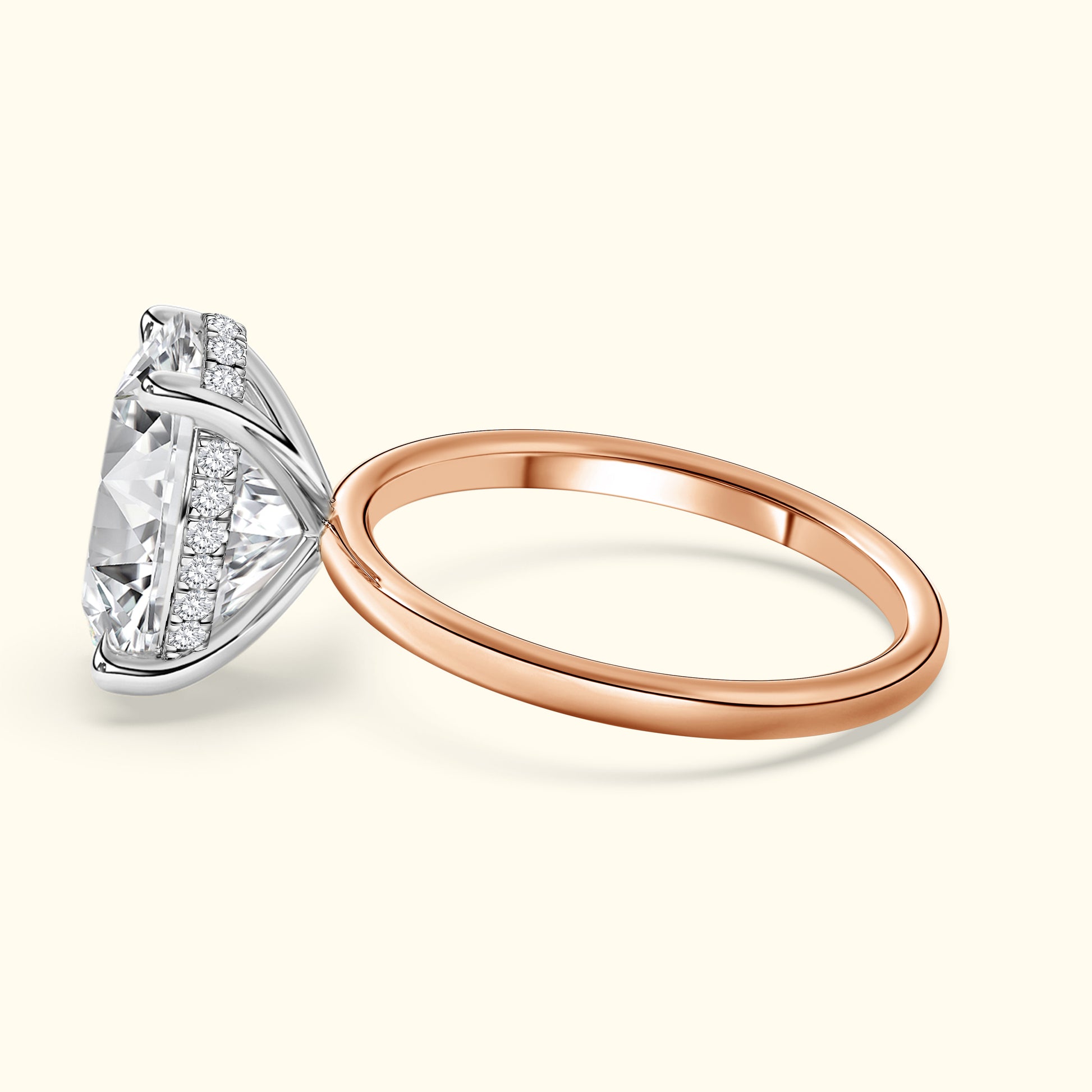 Elegant diamond engagement ring with a rose gold band and intricate side detailing.